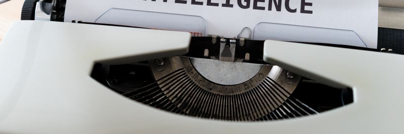 A close-up of a typewriter showcasing 'ARTIFICIAL INTELLIGENCE' on paper.