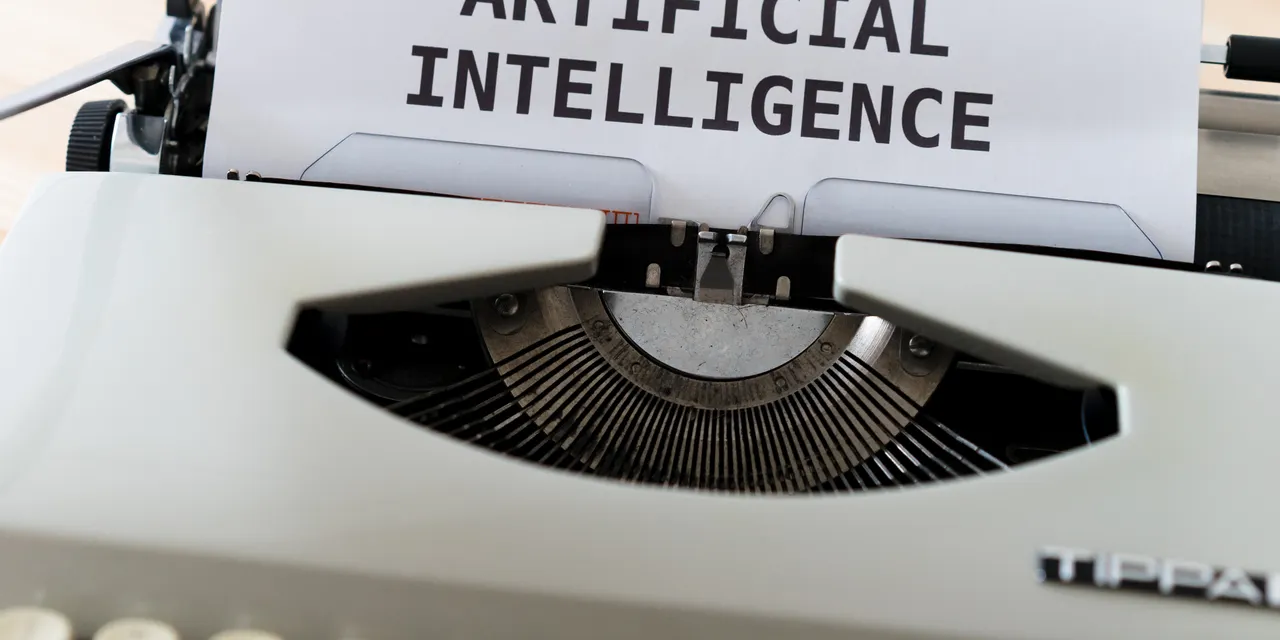 A typewriter typing the words 'Artificial Intelligence' on paper, GEO vs SEO in the age of AI answers