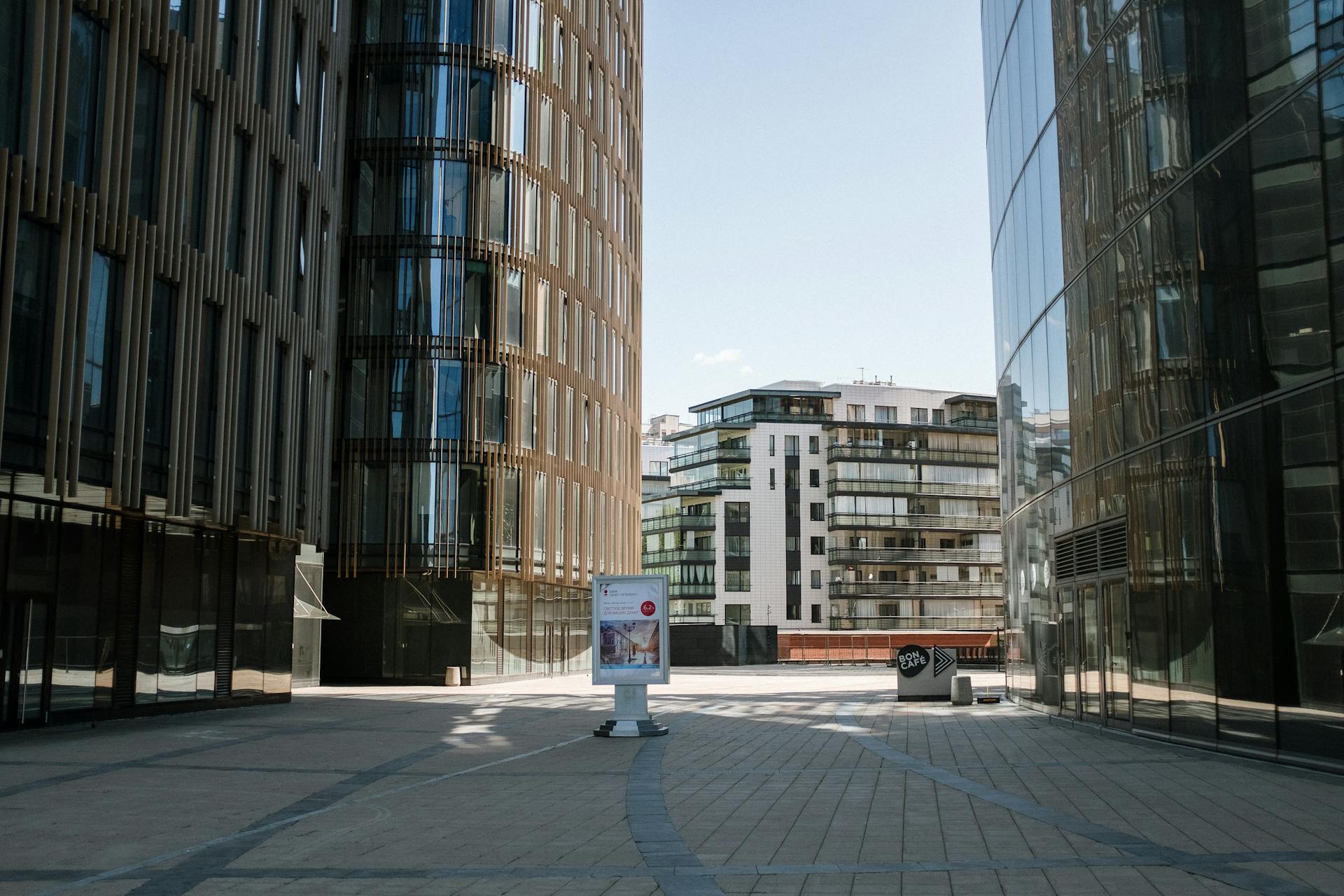 Sunlit cityscape with modern glass and steel buildings and urban design.