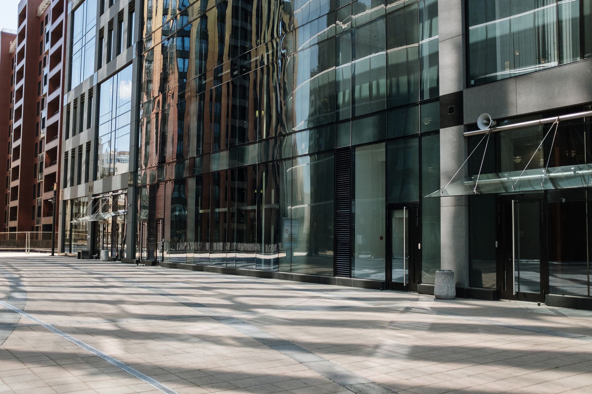 Empty cityscape featuring modern glass architecture and urban reflections.