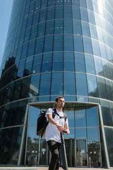Man riding electric scooter in city, symbolizing modern urban mobility.