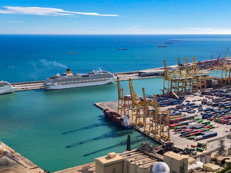 Scenic view of cargo containers and cruise ship at a harbor under blue skies.