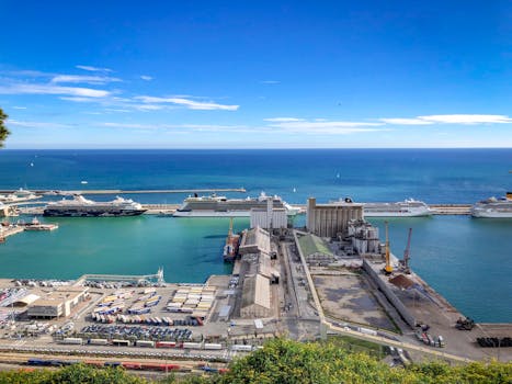 Scenic view of tropical harbor with moored big cruise liners and boats against tranquil blue sea on clear day