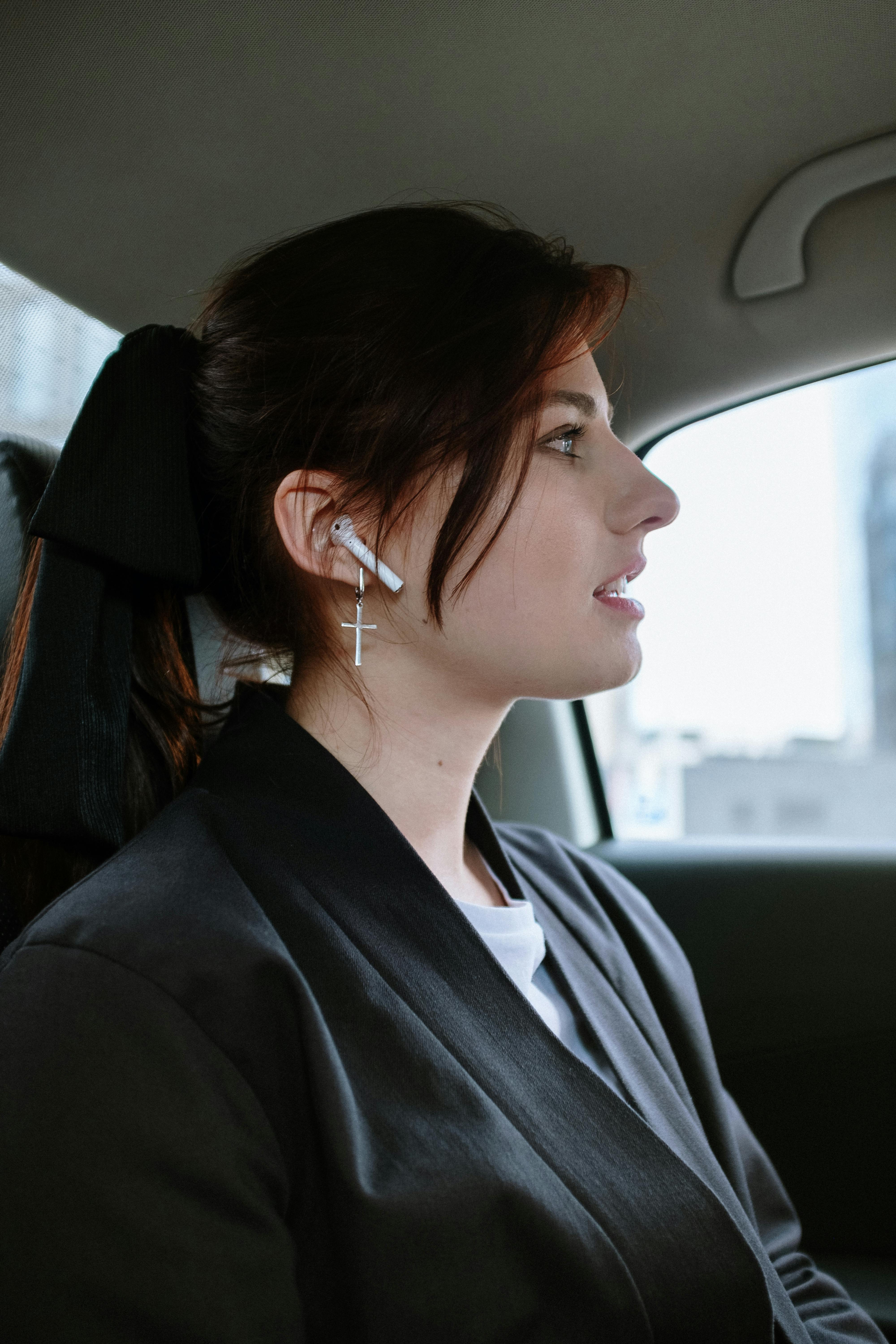 woman in black shirt wearing white earbuds