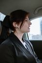 Woman in Black Shirt Wearing White Earbuds