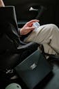 Person in Brown Pants Sitting on Black Leather Car Seat