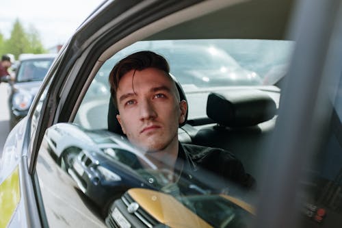 Free Man in Green Jacket Driving Car Stock Photo