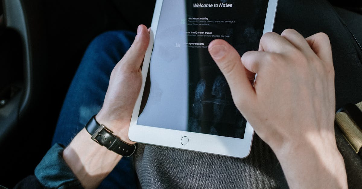 Person holding the iPad Mini 7 in one hand reading a digital magazine