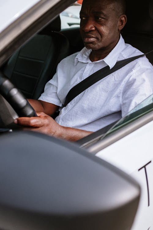 Free Man in White Button Up Shirt Driving Car Stock Photo