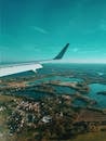 Airplane wing and sky over countryside