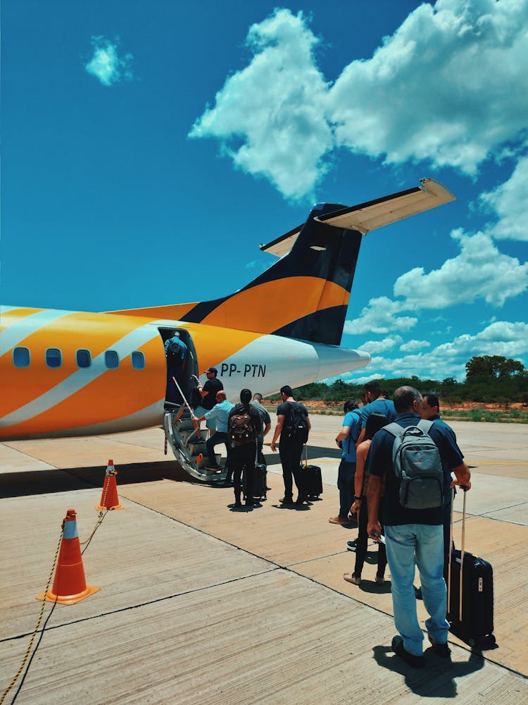 Group Of Tourists In Queue Before Boarding