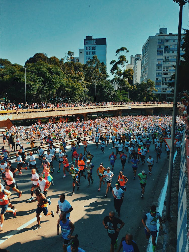 Diverse People Running Marathon On Crowded Road