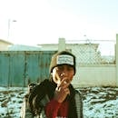 Young black guy smoking cigarette in wintertime