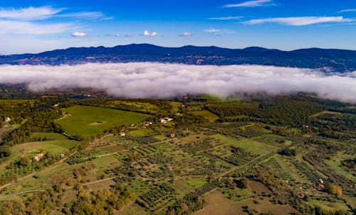 Picturesque view of green valley and blue hills with clouds above amazing landscape