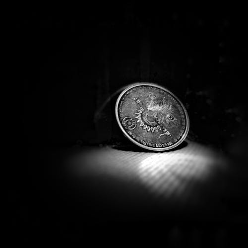 Silver Coin Against Black Background