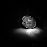 Silver coin on a dark surface — photo by Ishita Gupta on Pexels
