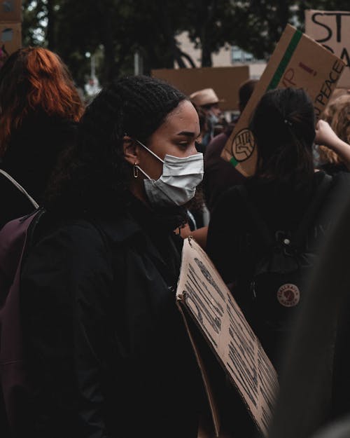Free Side View of a Protester in a Face Mask Stock Photo