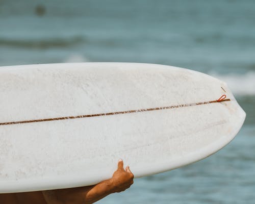 Person Holding White Surfboard