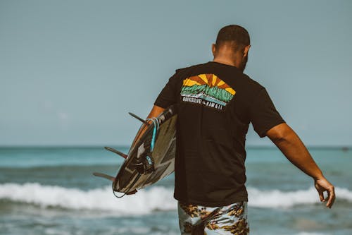 Man in Black Crew Neck T-shirt Standing Near Body of Water