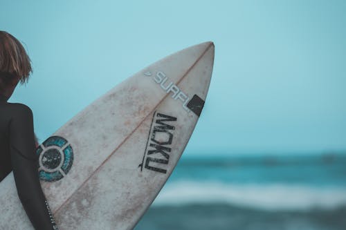 White and Blue Surfboard on Sea