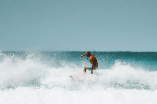 Man Surfing on Sea Waves