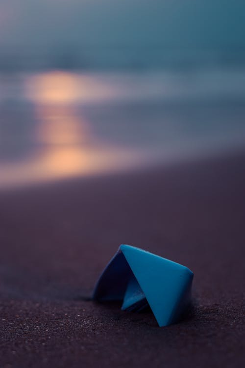 Blue Paper Boat on Sand