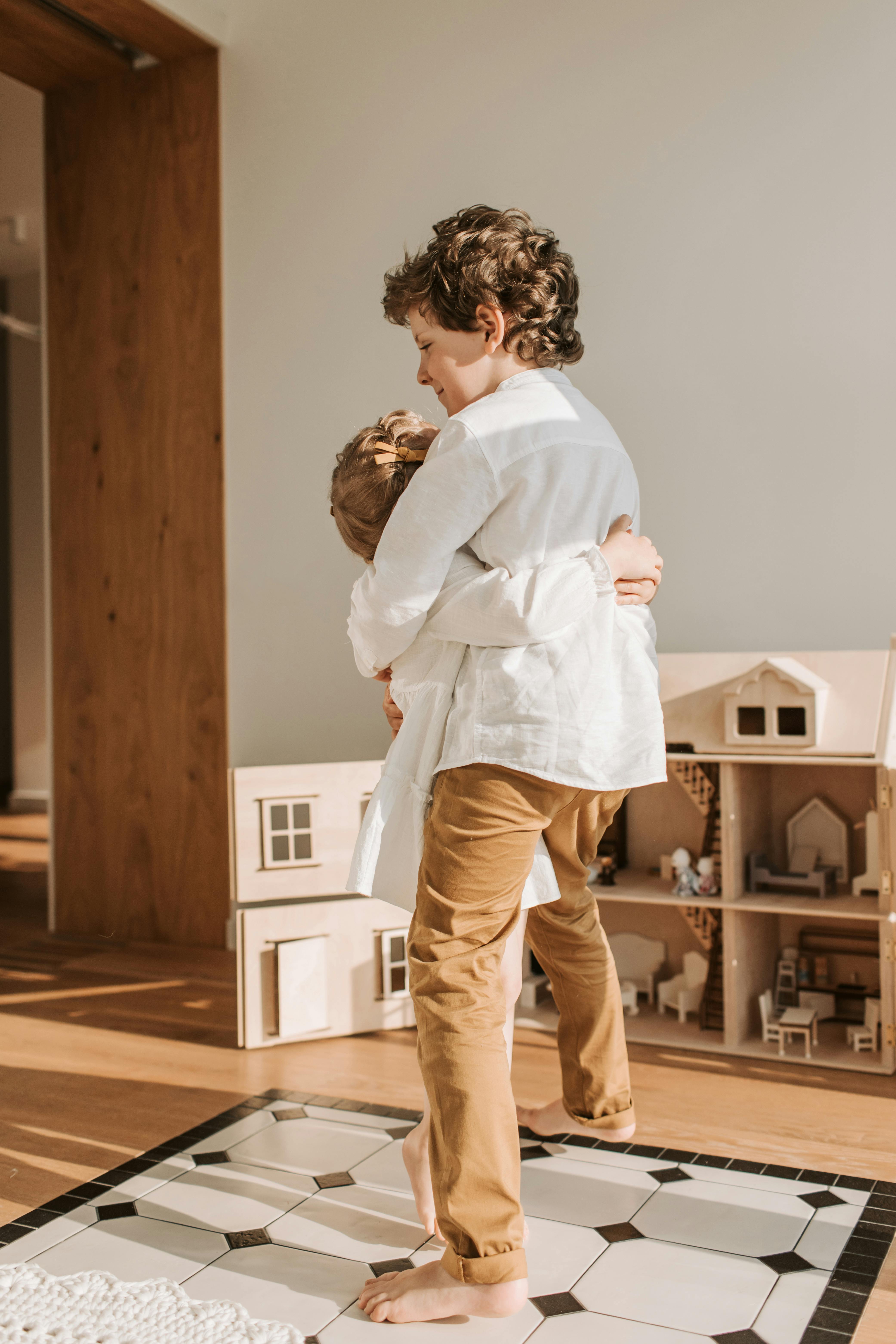 a brother and sister hugging each other