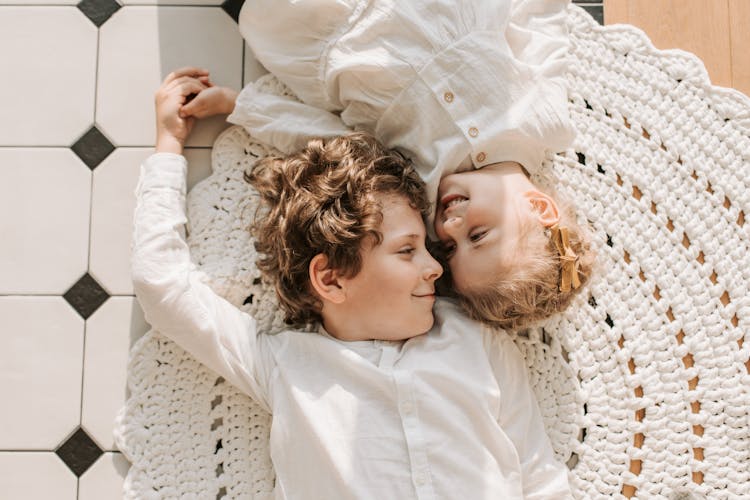 Overhead Shot Boy And A Girl Lying Down On The Floor