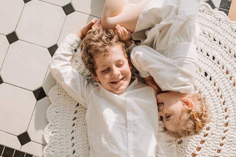 Overhead Shot Boy And A Girl Lying Down On The Floor