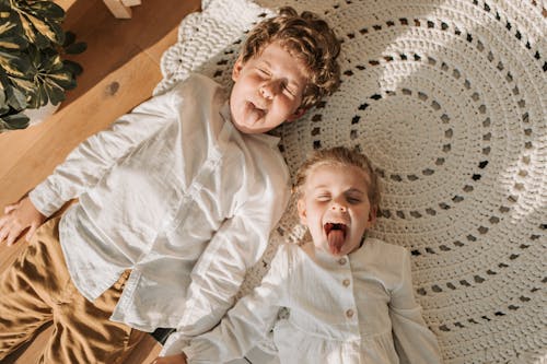 Free Overhead Shot of Children Lying on the Floor Stock Photo