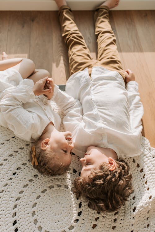 Free Happy Children Lying on the Floor Stock Photo