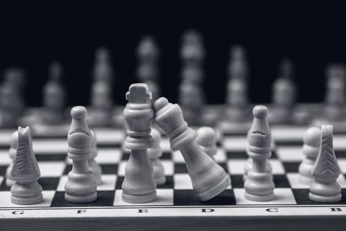 Free Close-up of chess pieces on a board, emphasizing strategic play with a leaning king. Stock Photo