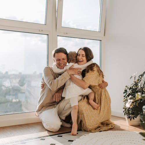 Free A Little Girl Hugging her Parents  Stock Photo