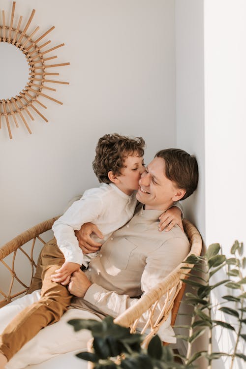 Free Father Getting a Kiss on the Cheek from his Son Stock Photo
