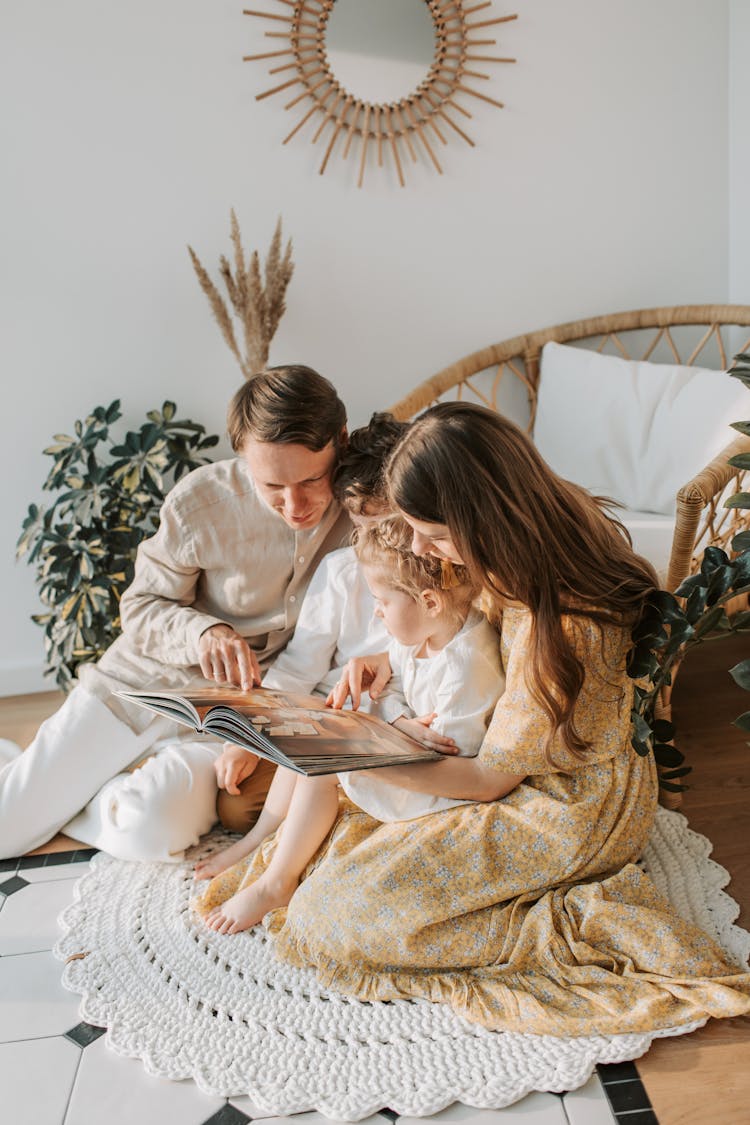 A Loving Family Spending Leisure Time Reading A Book Together