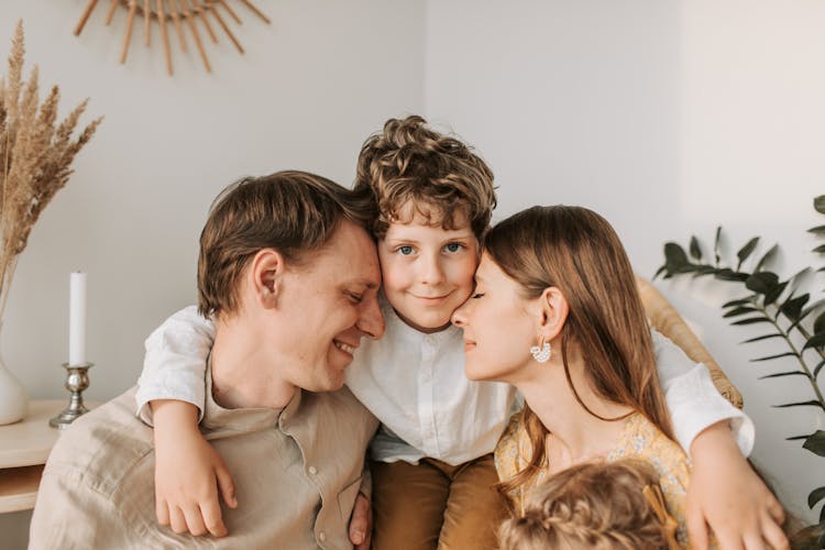 A Boy Hugging His Parents