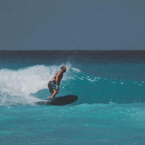 Man Surfing on Sea
