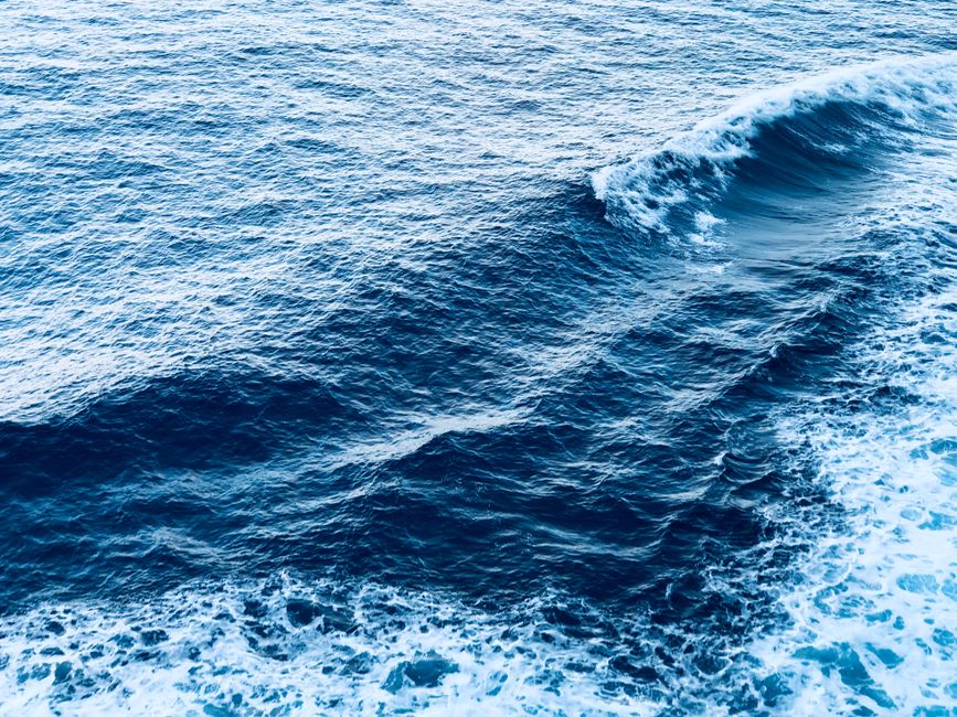 A captivating view of dynamic ocean waves with foam, showcasing the beauty of the sea.