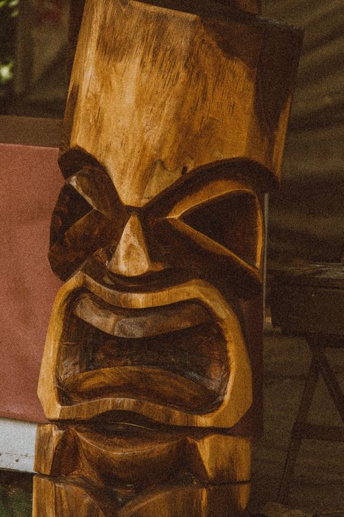 Free Close-up of a traditional Hawaiian tiki wood carving, showcasing intricate details and craftsmanship. Stock Photo