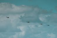 Helicopters on Flight  Under  Cloudy Sky