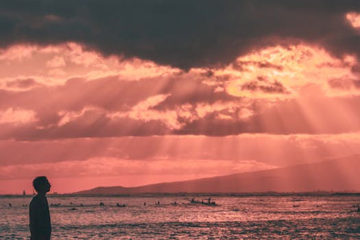 A stunning sunset view with a silhouette on Waikiki Beach, Honolulu, Hawaii.