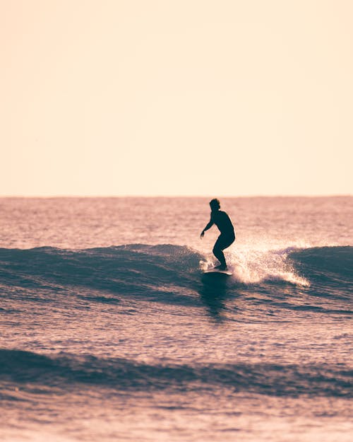 Free Man Surfing on Sea Stock Photo