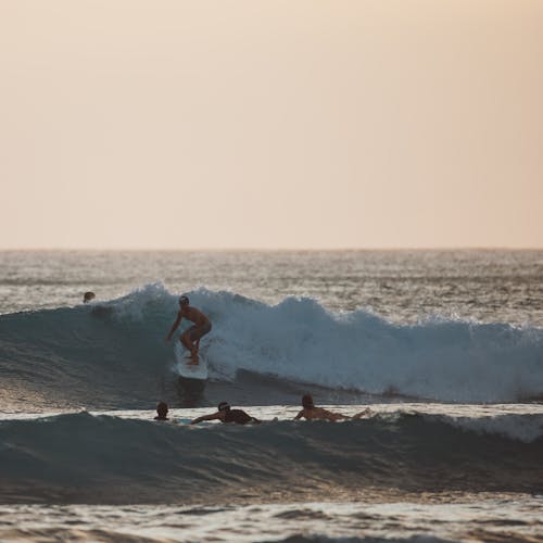 Man in Red Shirt Surfing on Sea Waves