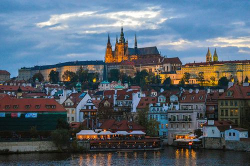 Free Capture the enchanting view of Prague Castle at twilight overlooking the historic cityscape. Stock Photo