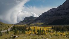 Green Trees Near Mountain Under White Clouds and Blue Sky