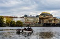 People Riding on Red and White Boat on River