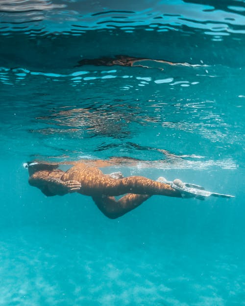 Free Man in Blue Shorts Swimming in Water Stock Photo