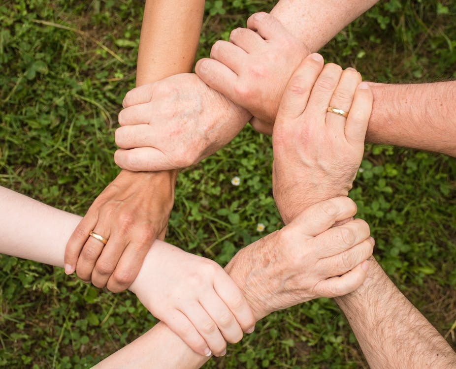 Group of People Holding Arms Mobile Phones for Charities