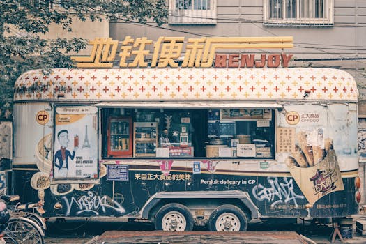 A vintage food truck parked on a street in Beijing, China, offering local delicacies.