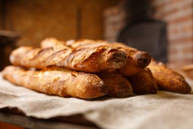 Fresh baguettes dusted with flour at the bakery